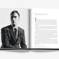 Open book displaying a black and white portrait of a man on the left page and introductory text on the right page. The man, reminiscent of Dior: Raf Simons' haute couture style, is wearing a suit with a floral boutonniere—an image sure to captivate fashion enthusiasts.