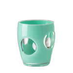 The Mario Luca Giusti Fisheye Acrylic Collection includes a green tumbler with circular cut-outs on the sides, ideal for any outdoor table setting.