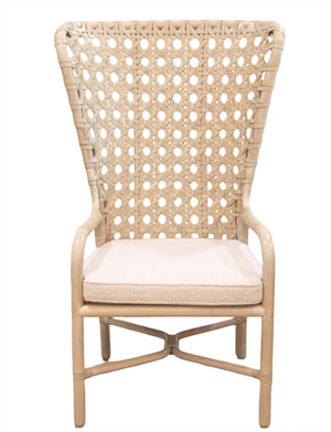 The Exalt Host Chair is a high-back wicker chair featuring an intricate woven pattern and a cushioned seat, handcrafted using classic techniques from light-colored wood.