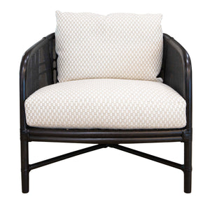 A Plaid Lounge Chair with a black wooden frame, curved armrests, and cushioned seat, featuring rattan and caning details alongside a woven beige and white checkered pattern on the upholstery.