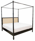 A black Willa Raffia Bed, King with turned bedposts, featuring a beige upholstered headboard and a white sheet.