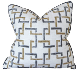 A Sekai Charcoal Cinnamon Pillow with a geometric pattern featuring L-shaped designs in gold and gray, crafted from the finest materials. This custom-made pillow showcases special attention to detail, making it a splendid addition to any décor.