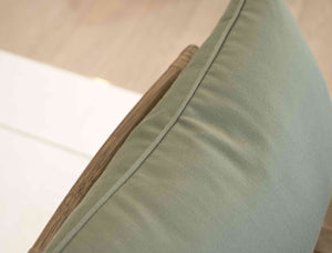 Close-up of a Lucido D'albano Lumbar Pillow on a chair, showcasing the finest materials and special attention to detail.