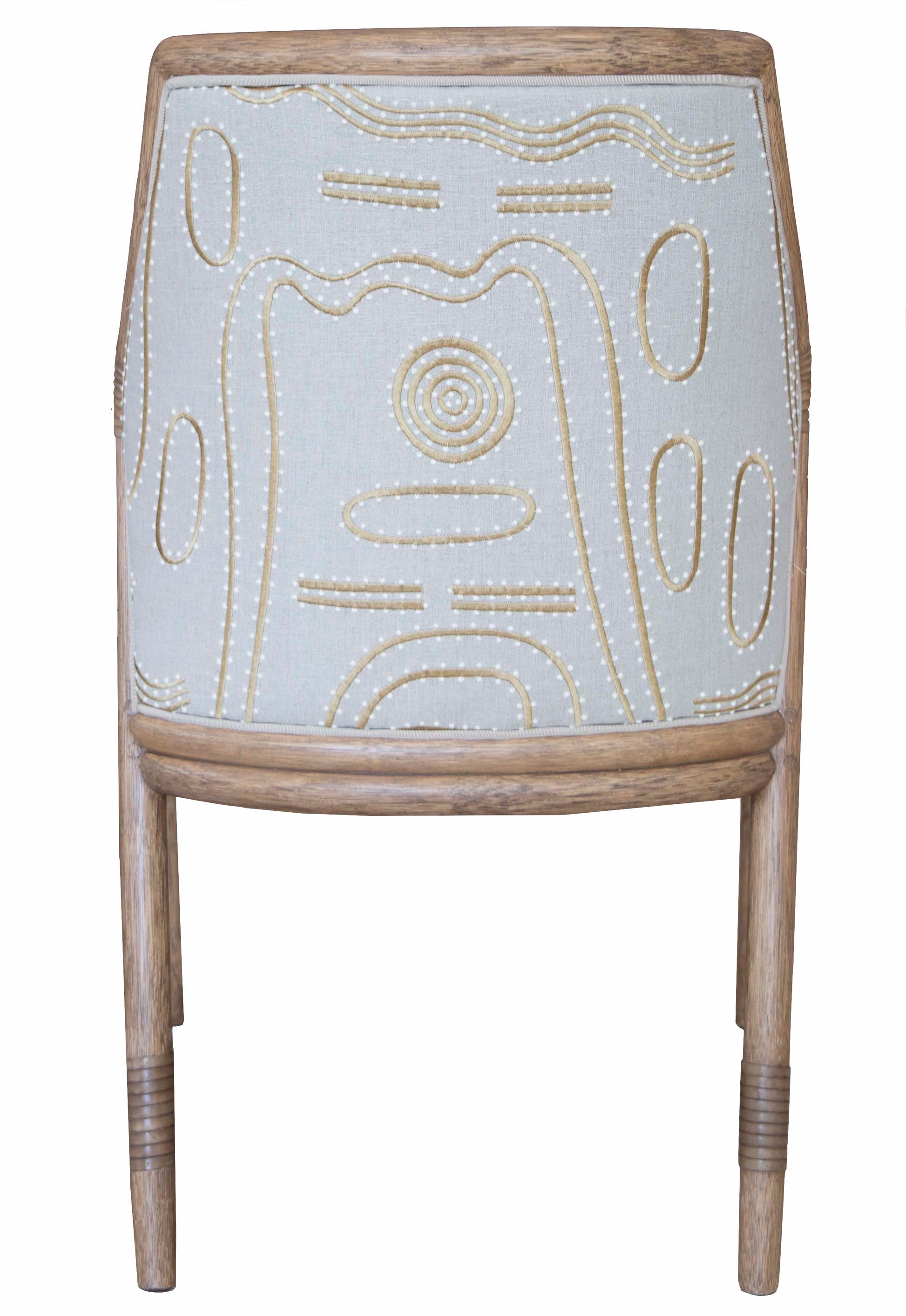 Back view of the Lantana Side Chair showcasing McGuire craftsmanship with a decorative, light-colored fabric on the backrest featuring abstract stitched patterns in a contrasting light brown thread.