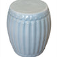 A Porcelain Ribbed Garden Stool with a ribbed, barrel-shaped design and a glossy light blue glaze.