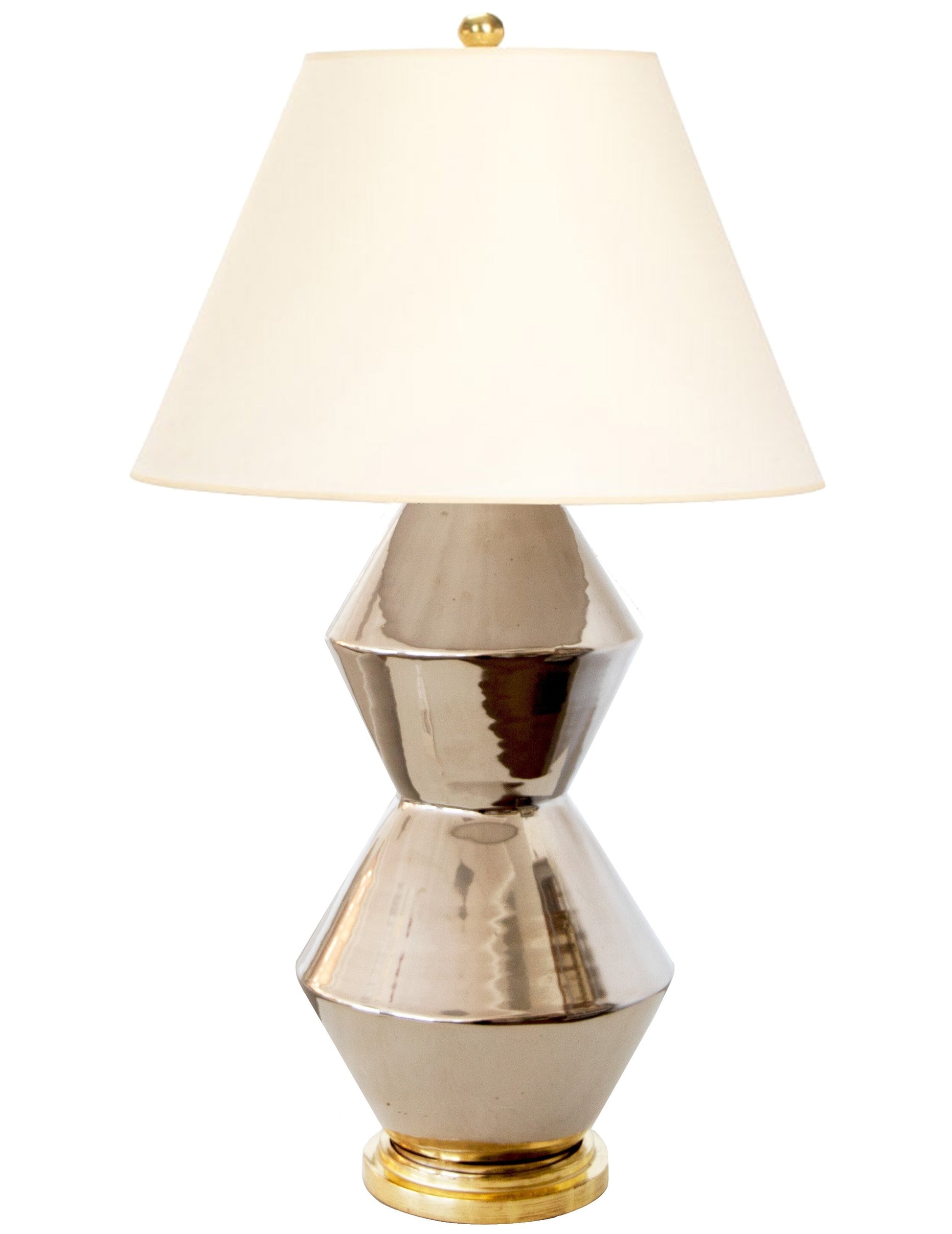 The David Medium Table Lamp in Platinum Luster features a geometric design and a white lampshade, evoking the elegance of hand-thrown lamps while seamlessly blending modern aesthetics with traditional craftsmanship.