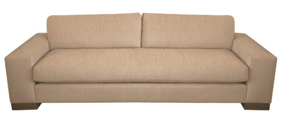 A beige, two-cushion Burke Sofa with wide armrests and dark wooden legs, viewed from the front, exudes modern flair with subtle industrial elements. Part of the Burke Collection, it combines elegance with contemporary comfort seamlessly.