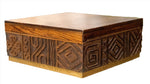 A square wooden box made from mango wood with intricate carved symbols on the sides and a plain smooth top. The carvings feature geometric and abstract patterns, making this Oti Brown Box Collection a unique piece of craftsmanship.