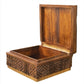 A wooden box with intricate carved symbols on the sides is shown with the lid open, revealing an empty interior. Fashioned from Mango wood, this Oti Brown Box Collection exudes a rustic charm.