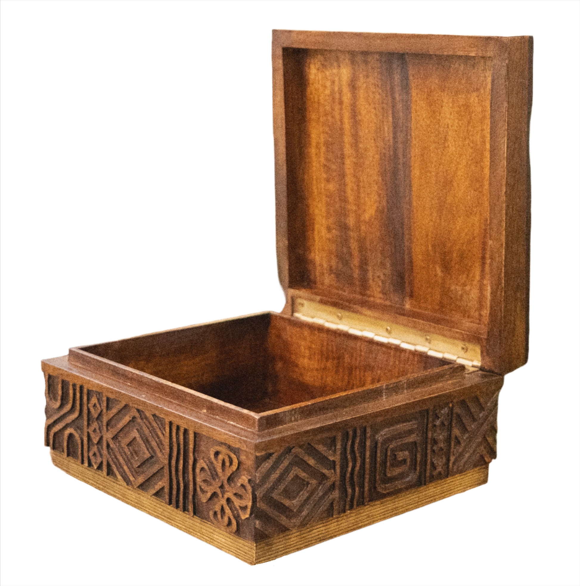 A wooden box with intricate carved symbols on the sides is shown with the lid open, revealing an empty interior. Fashioned from Mango wood, this Oti Brown Box Collection exudes a rustic charm.