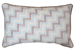 The Ziggy Sky Lumbar Pillow features a geometric zigzag pattern in light blue, cream, and brown with dark edge piping, crafted from premium materials—ideal for adding stylish custom-made flair to your space.