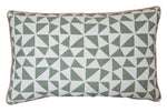 The Circus Lumbar Pillow is a custom-made rectangular pillow featuring a green and white geometric triangle pattern and finished with beige piping around the edges.