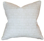 The Tane Light Dusk Pillow is a custom-made, square throw pillow featuring a geometric repeating pattern in light beige and white, crafted from premium materials and shown against a plain white background.