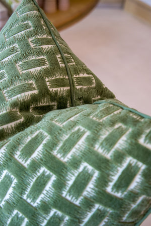 Close-up of two Chambord Velvet Leaf Pillows, custom-made in green velvet with a soft surface and textured geometric white pattern.