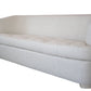 The Aldo Sofa, in light beige upholstery, features a high back and low arms for a modern look with timeless appeal, shown on a white background.