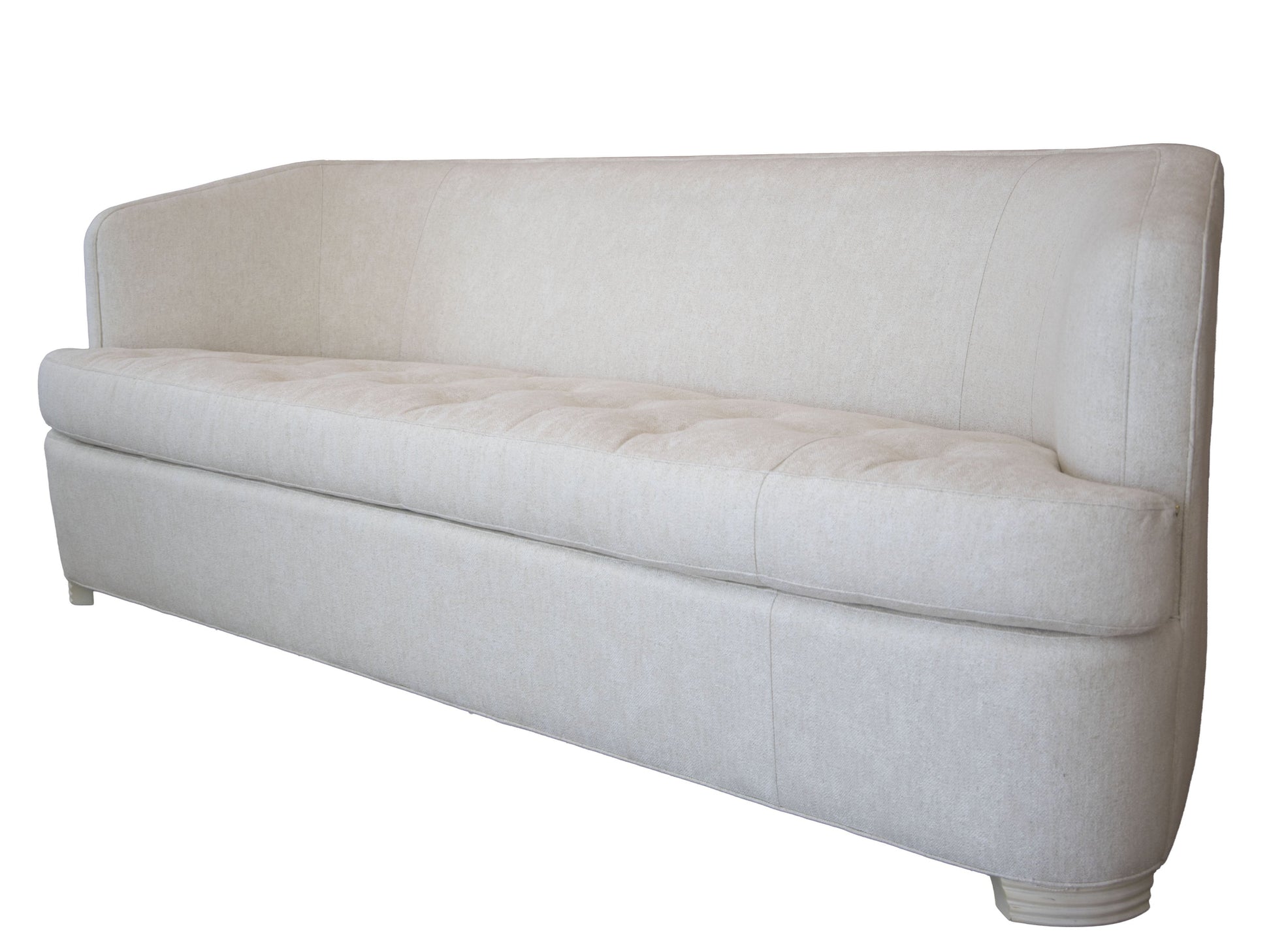 The Aldo Sofa, in light beige upholstery, features a high back and low arms for a modern look with timeless appeal, shown on a white background.
