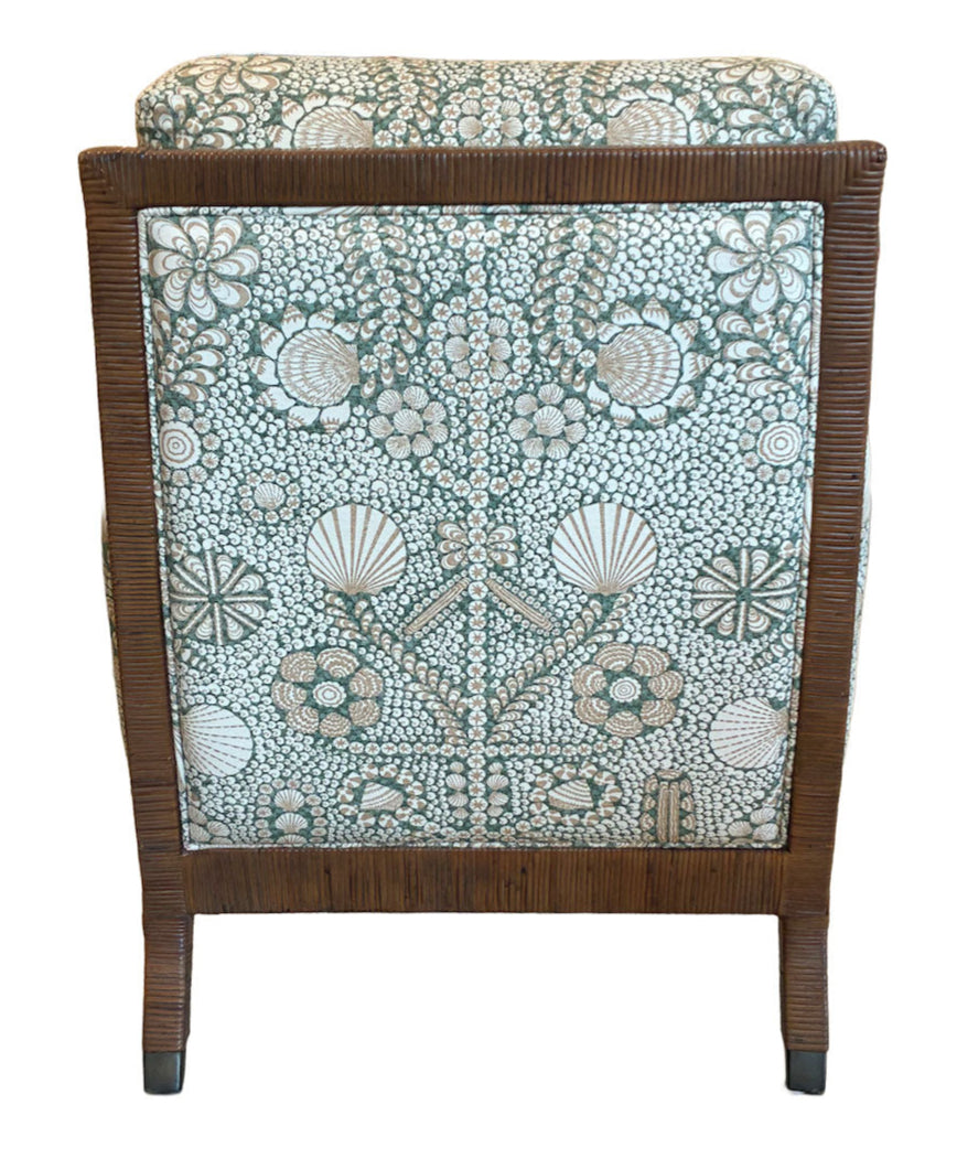 The St. Germain Lounge Chair is shown from the back, highlighting its wooden frame and green and white fabric with a French-inspired floral and shell pattern.