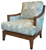 The St. Germain Lounge Chair features wooden armrests and legs, upholstered in blue and white floral and geometric fabric, inspired by classic French design.