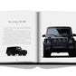 Open book displaying an image of a black Mercedes-Benz G63 AMG on the left page and a front view of the same vehicle on the right page. The left page features a text description, showcasing Iconic: Art, Design, Advertising, and the Automobile's allure in seamless advertising brilliance.