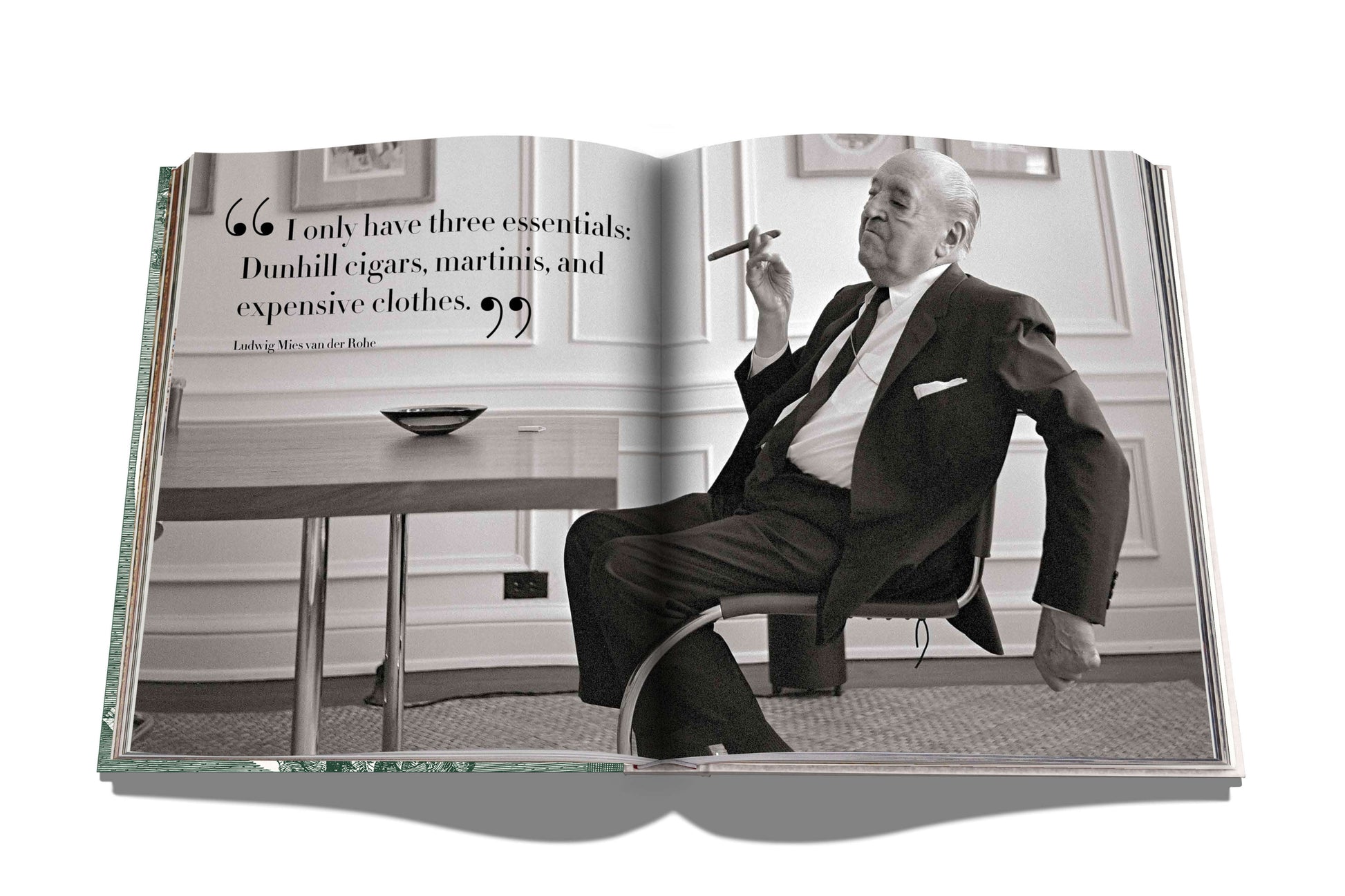 A book open to a black-and-white photo of a man in a suit, seated and smoking. The page features a quote about his essentials: hand-rolled Dunhill cigars, martinis, and expensive clothes. This could be right out of "The Impossible Collection of Cigars" or any ultimate collection for the sophisticated smoker.