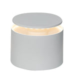 The Zafferano PushUp Pro Lamp Collection features a cylindrical white rechargeable table lamp with a flat, circular top and soft light glowing from beneath the lid.