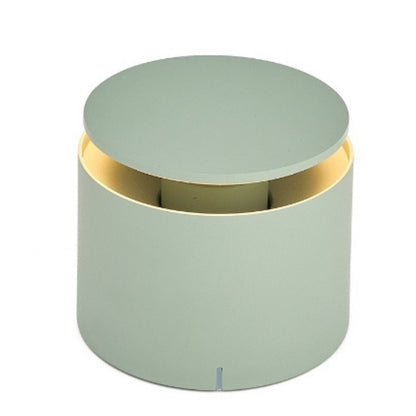 The Zafferano PushUp Pro Lamp Collection features a round, light green rechargeable table lamp with a matching lid, slightly open to reveal a yellow interior.