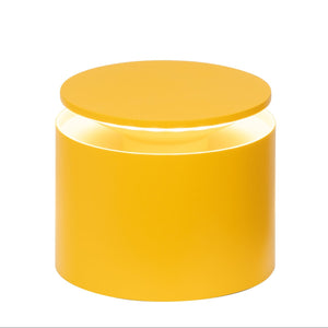 The Zafferano PushUp Pro Lamp Collection features a modern, round yellow cordless table lamp with a cylindrical base and flat circular top, emitting light from the gap between the base and top.