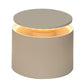 The Zafferano PushUp Pro Lamp Collection features a round, beige cordless table lamp with a raised circular top that emits a warm glow, adding modern style and convenience to any space.