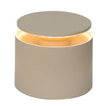 The Zafferano PushUp Pro Lamp Collection features a round, beige cordless table lamp with a raised circular top that emits a warm glow, adding modern style and convenience to any space.