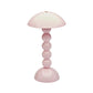 The Addison Ross Bobbin LED Cordless Lamp is a pink portable light with a dome-shaped shade, stacked spherical base inspired by bobbin lamps, and a glossy finish.