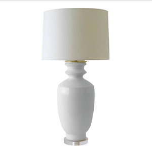 The Marathon Table Lamp in Fossil Grey features a hand-thrown ceramic base with a custom glaze, wide and round in shape, topped with a cylindrical white lampshade, all set against a plain white background.