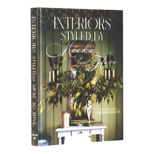 The hardcover book "Interiors: Styled by Mieke ten Have" features a cover with a decorated console table, mirror, greenery, and accents of Pattern Play.
