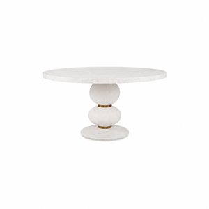 The Misty Country Dining Table features a round white top and a sculptural hand-turned base with three stacked, rounded shapes, showcasing minimalist Italian design.