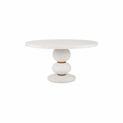 The Misty Country Dining Table features a round white top and a sculptural hand-turned base with three stacked, rounded shapes, showcasing minimalist Italian design.