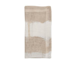 The KS Watercolor Stripe White & Natural is a folded beige and white linen napkin featuring an abstract, watercolor-inspired stripe design—ideal for adding a touch of sophistication to your summer table.
