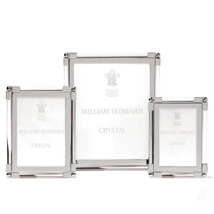 Displayed are three elegant photo frames from the William Yeoward Crystal Classic Clear Frame Collection. These frames feature a tarnish-resistant silver finish and have clear glass fronts, with "William Yeoward Crystal" printed on the inserts to highlight their sophisticated nickel-plated design.