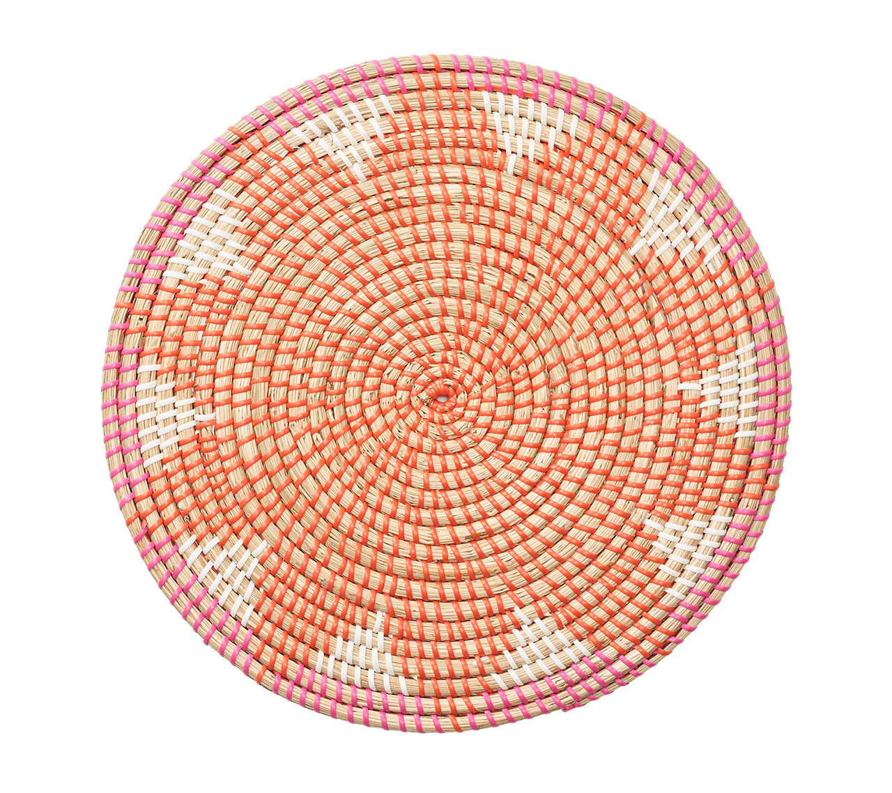 The Kim Seybert Majorelle Placemat Collection features round woven basket trays made from natural seagrass with a spiral orange, white, and pink pattern, white triangular accents, and a flat design, shown on a white background.