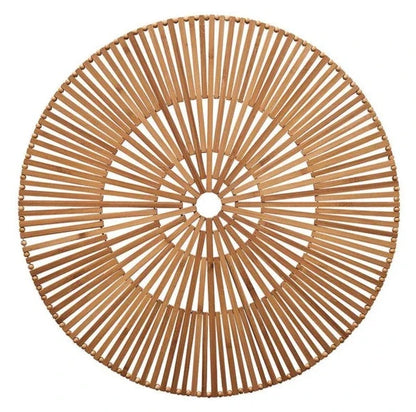 The Kim Seybert Spoke Placemat is a precision hand-cut, round bamboo placemat with a radial design of evenly spaced slats and a small open center forming a geometric pattern.