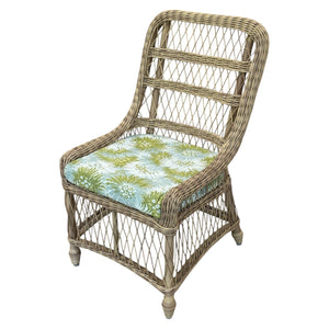 The Outdoor Lemonade Chair in Bimini Moss features a green, blue, and white floral cushion. Its open weave lattice back, sides, and curved edges bring elegance and charm to any setting.