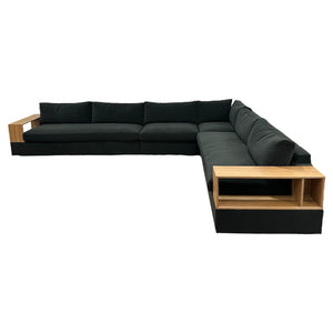 The Embrace Sectional in Vacation Charcoal offers spacious L-shaped seating with wooden armrests and built-in shelving, showcasing modern design against a white background.