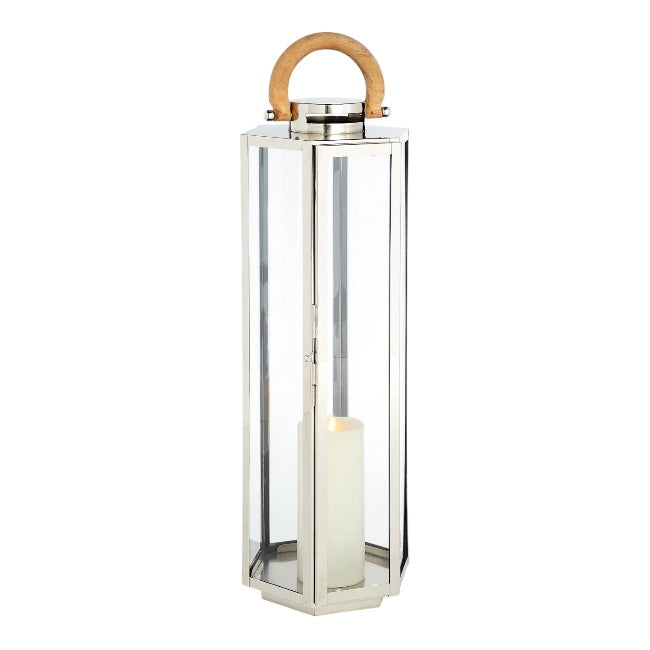The Dockside Lantern is a tall, rectangular design made of glass and stainless steel, featuring elegant teak handles and housing a white pillar candle inside.