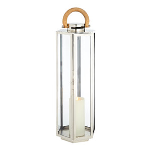 The Dockside Lantern is a tall, rectangular design made of glass and stainless steel, featuring elegant teak handles and housing a white pillar candle inside.