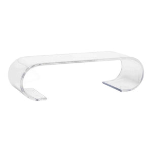 The Chelsea Cocktail Table in Acrylic features a clear, scroll-inspired curved U-shaped design with open space beneath.