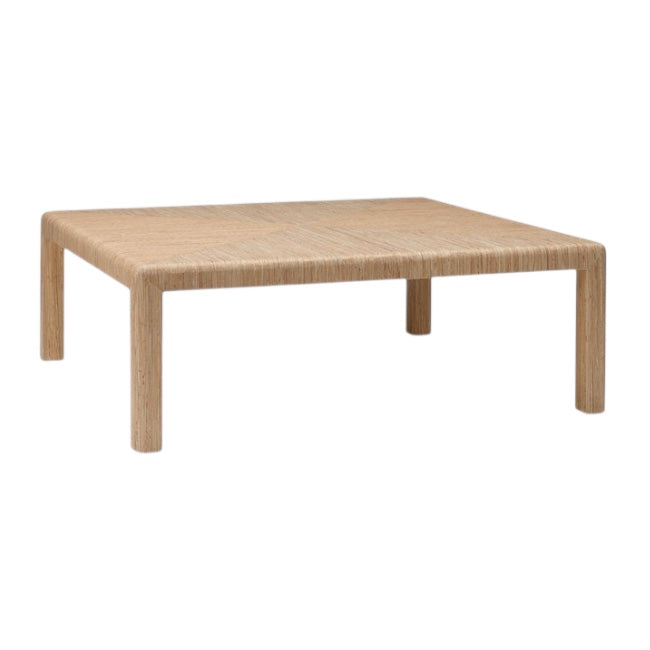 The Parson Coffee Table in Natural Hemp is a rectangular, light wood table with four legs, a minimal modern design, and a subtle triangle pattern woven into its hemp surface.