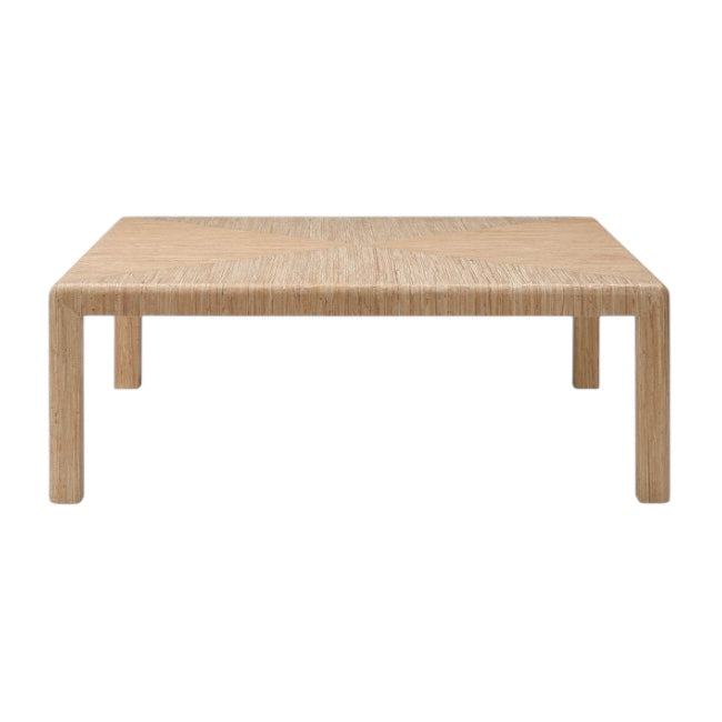 The Parson Coffee Table in Natural Hemp is a rectangular, light wood coffee table with four straight legs and a front-facing subtle woven hemp triangle pattern.