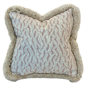 The Daphne's Feathers Rose Pillow showcases a textured light pink and white patterned fabric, accented with a thick, fluffy beige trim for an elegant finish.
