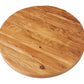 A round wooden table top with a natural finish and visible grain patterns, featuring the Classic Trivet Top Lazy Susan.