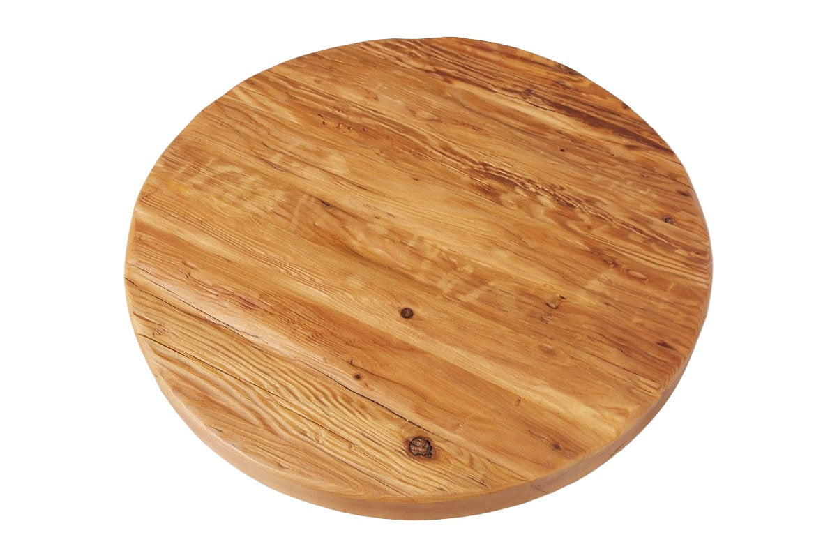 A round wooden table top with a natural finish and visible grain patterns, featuring the Classic Trivet Top Lazy Susan.