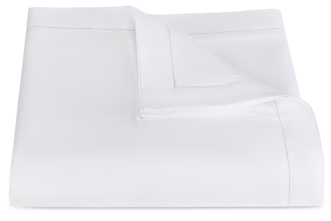 A folded white blanket with hemstitch detailing along the edges, displayed against a plain background, showcasing the craftsmanship found at Matouk's factory.

Revised Sentence: A folded white blanket with hemstitch detailing along the edges, displayed against a plain background, showcasing the craftsmanship found in the Matouk Roman Linen Hemstitch Bedding Collection, White.