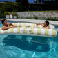 Two people relax on the SUNNYLiFE Luxe Twin Hammock Float Casa Sand Stripe, floating in a pool with a house and lush greenery in the background, capturing Australia’s summer style.